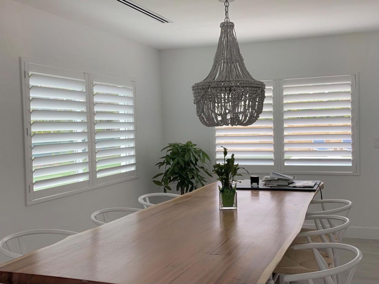 Hidden tilt arm shutters in dining room