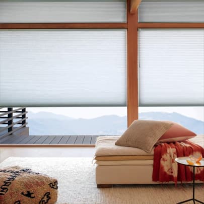 Duette honeycomb shades on large living room windows plantation shutters on arched window