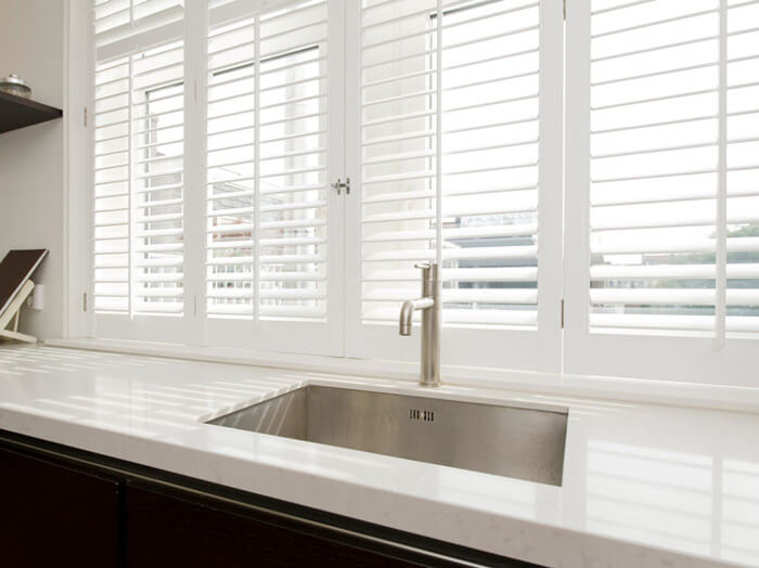 SHUTTERS_BLACK_SLIDER_DINKIT-compressed plantation shutters in a kitchen