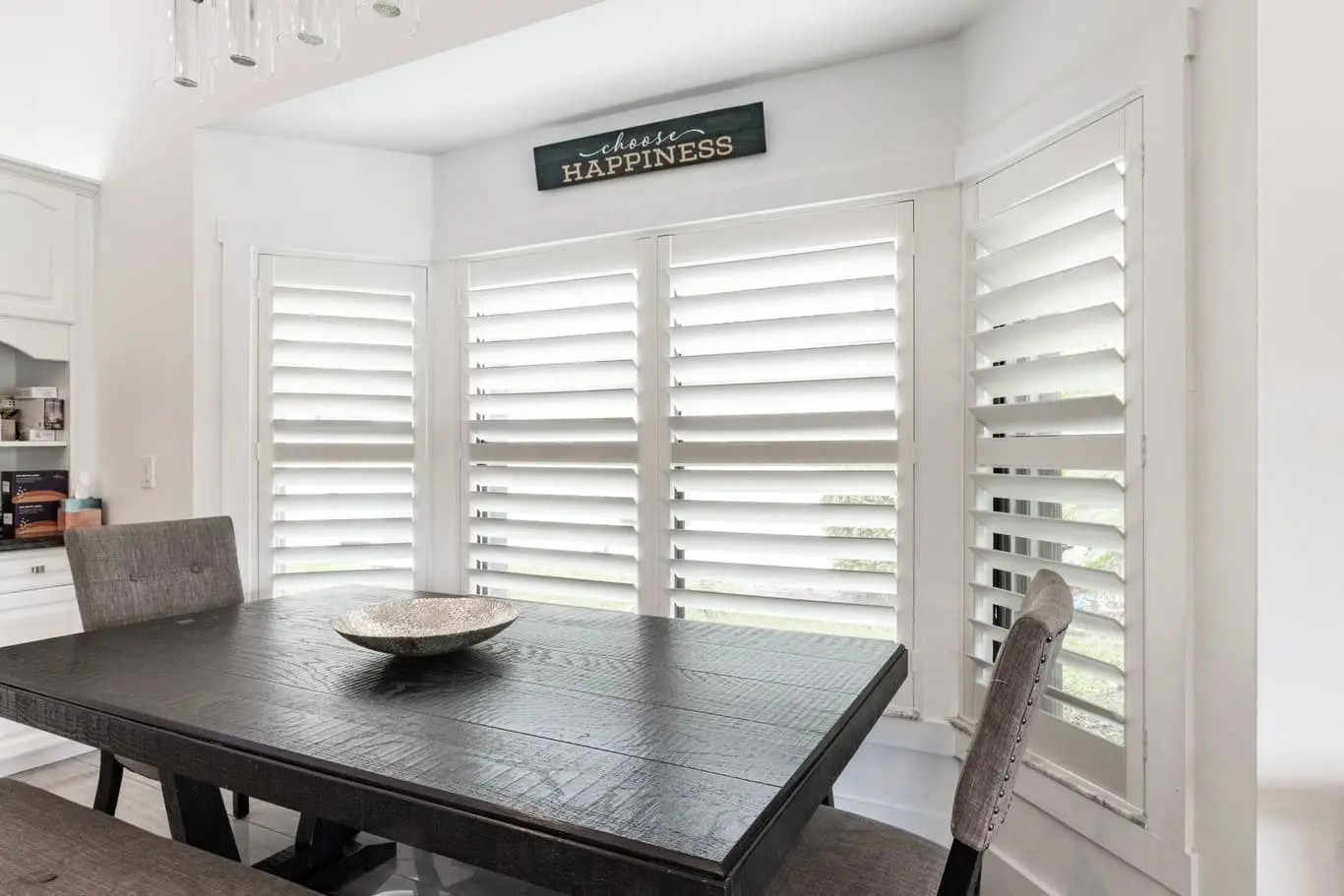 plantation shutters with large louvers in dining room